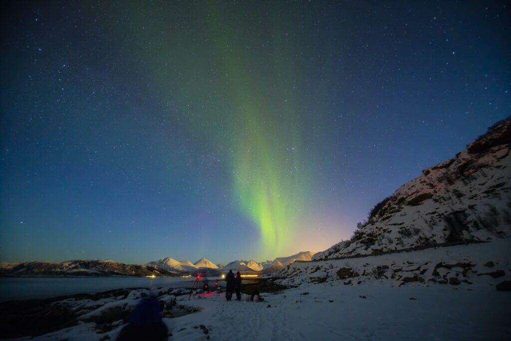 Gazing Northern lights above the reindeer camp in a Sami Farm in Tromso. 