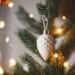 Scandinavian Christmas decor baubel hanging on christmas tree branch